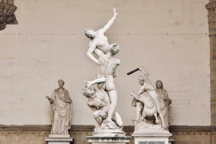 a group of people sitting in front of a building