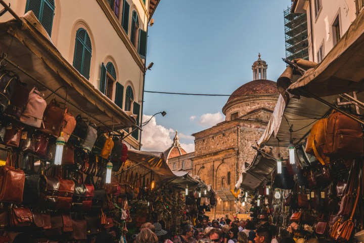 a crowded city street in front of a building