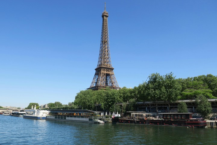 a small clock tower in the middle of a body of water