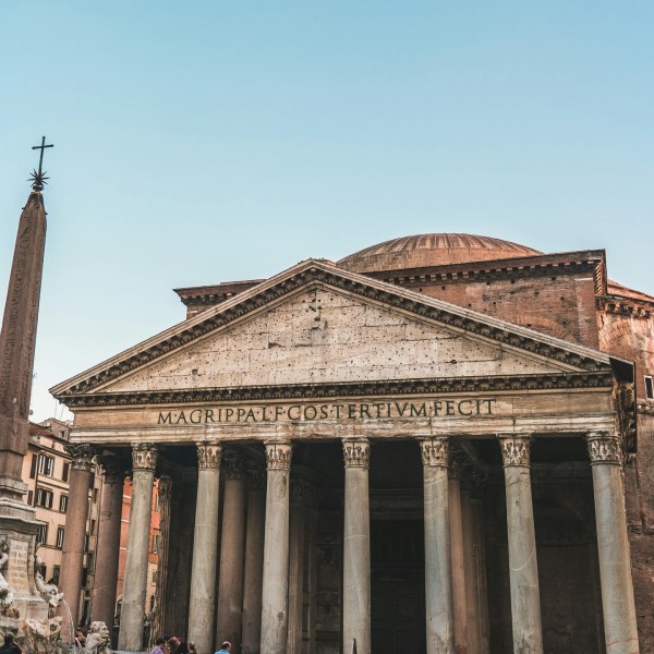 a large stone building with Pantheon, Rome in the background