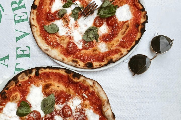 a pizza sitting on top of a cutting board