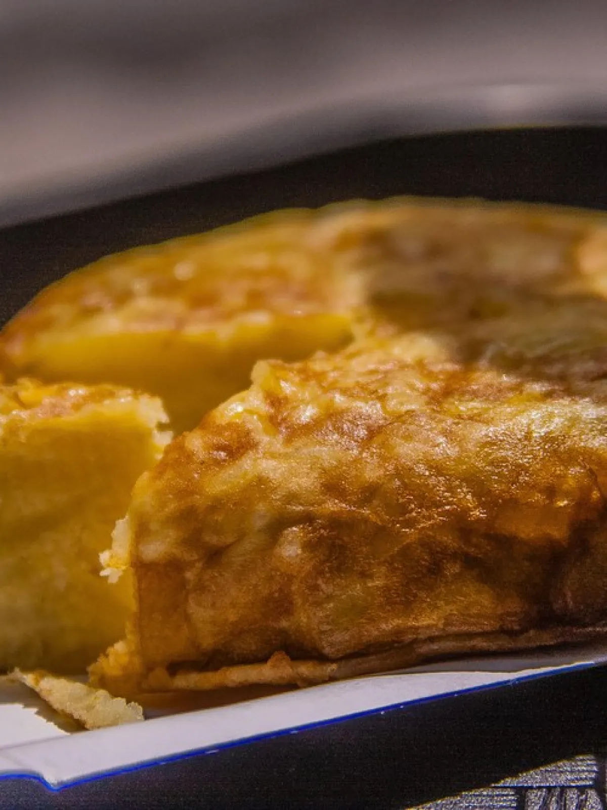 Close-up of sliced Spanish tortilla on a white plate.